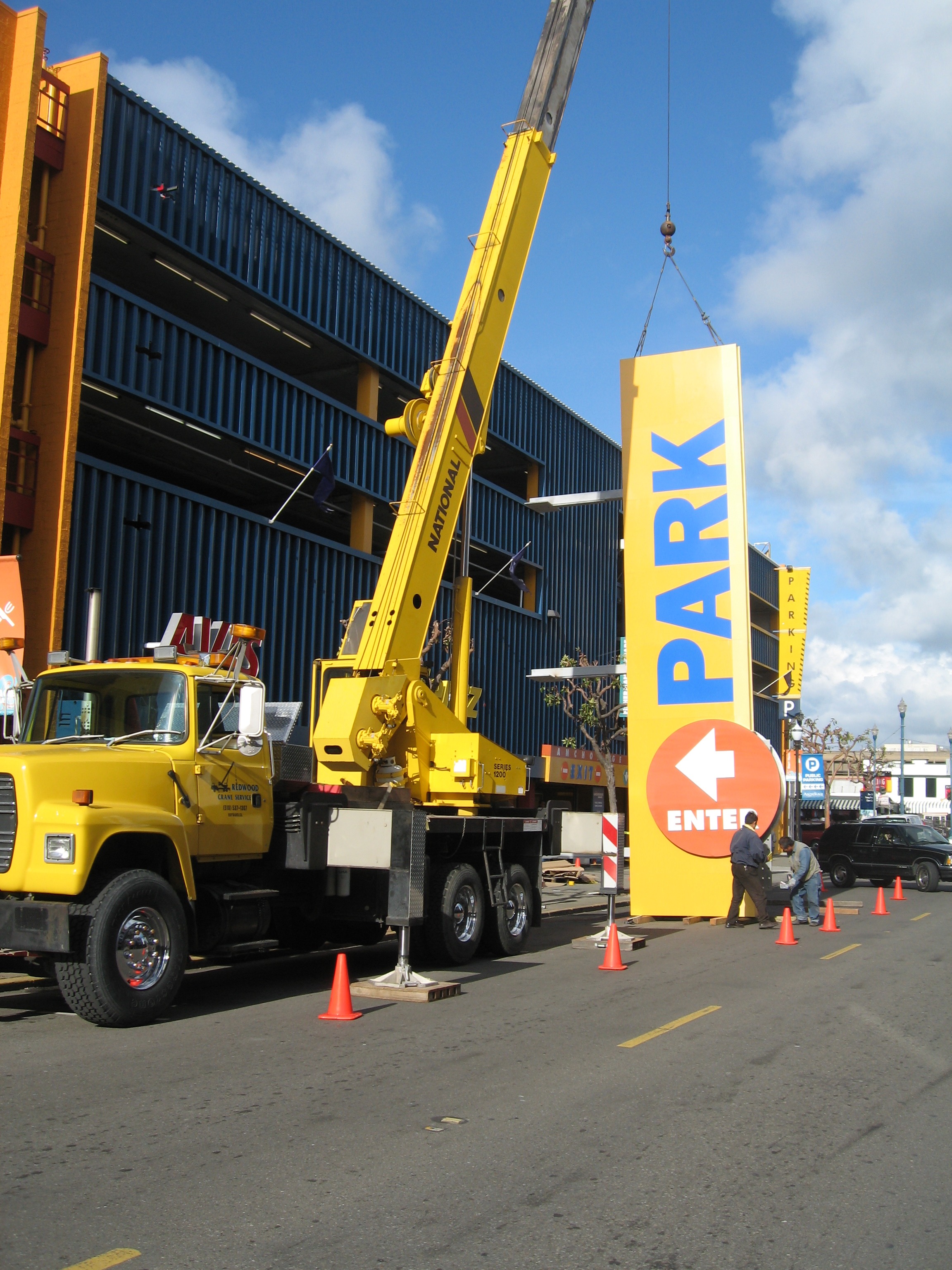 Crane lifting the PARK tower sign into place during installation
