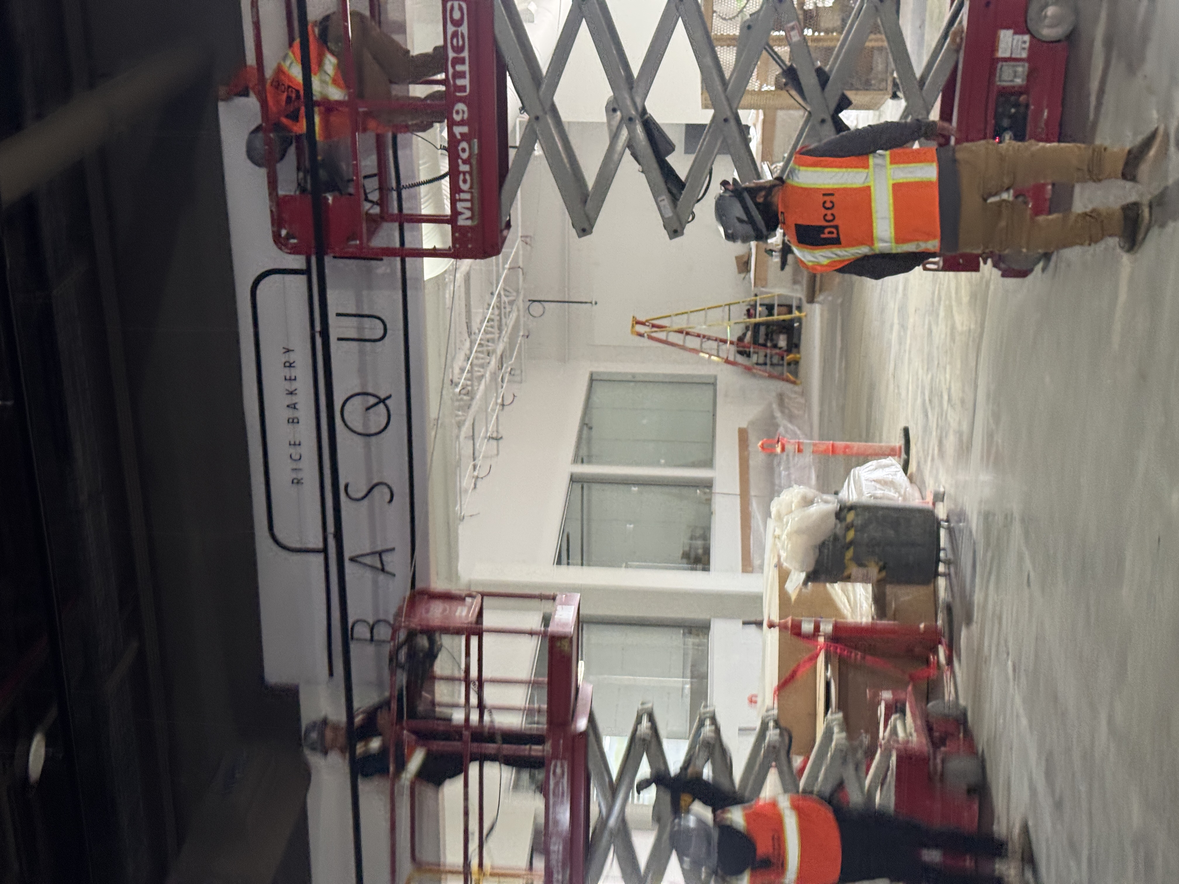 DT Signs crew installing signage on lift