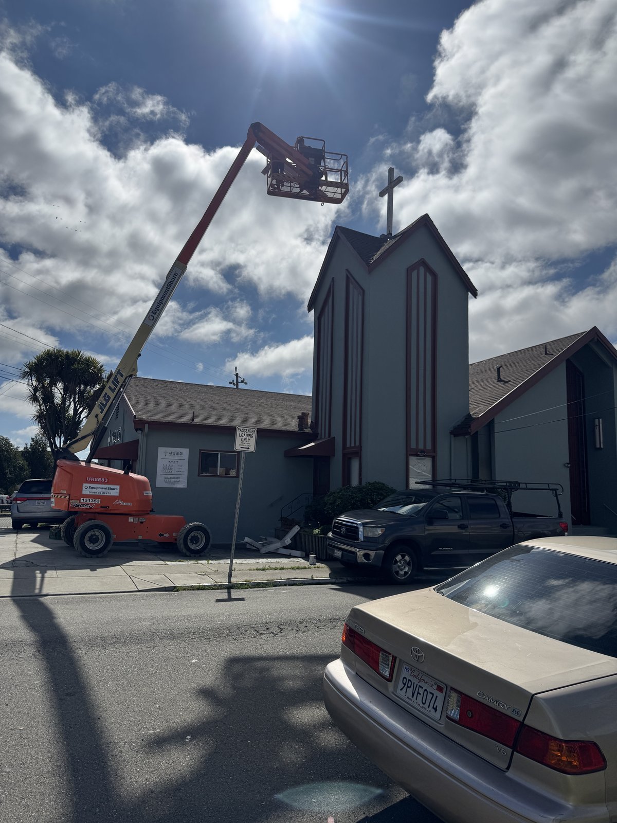 Boom lift installing a steeple cross at Saebit Church