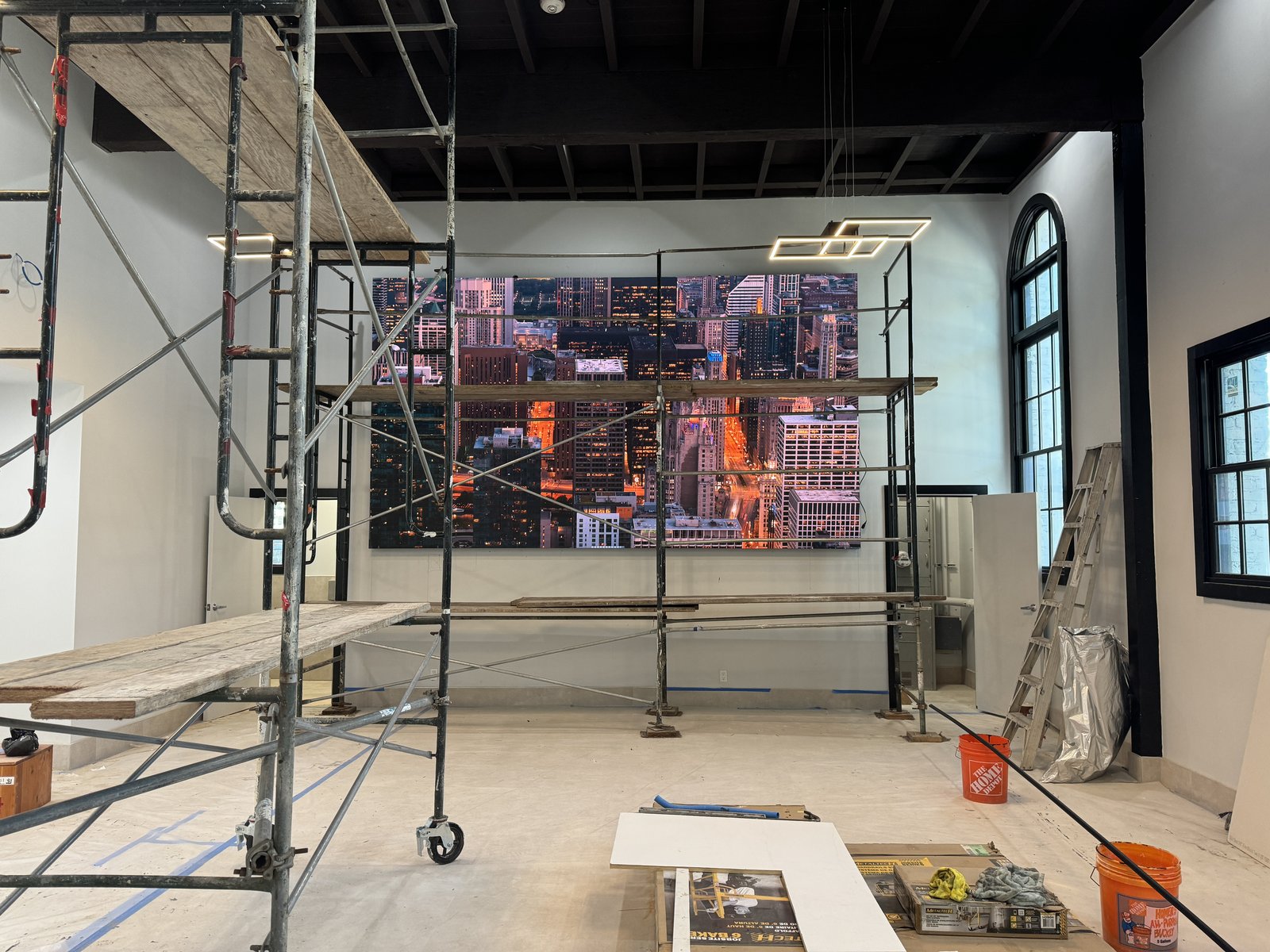 Large skyline wall panel being installed from scaffolding