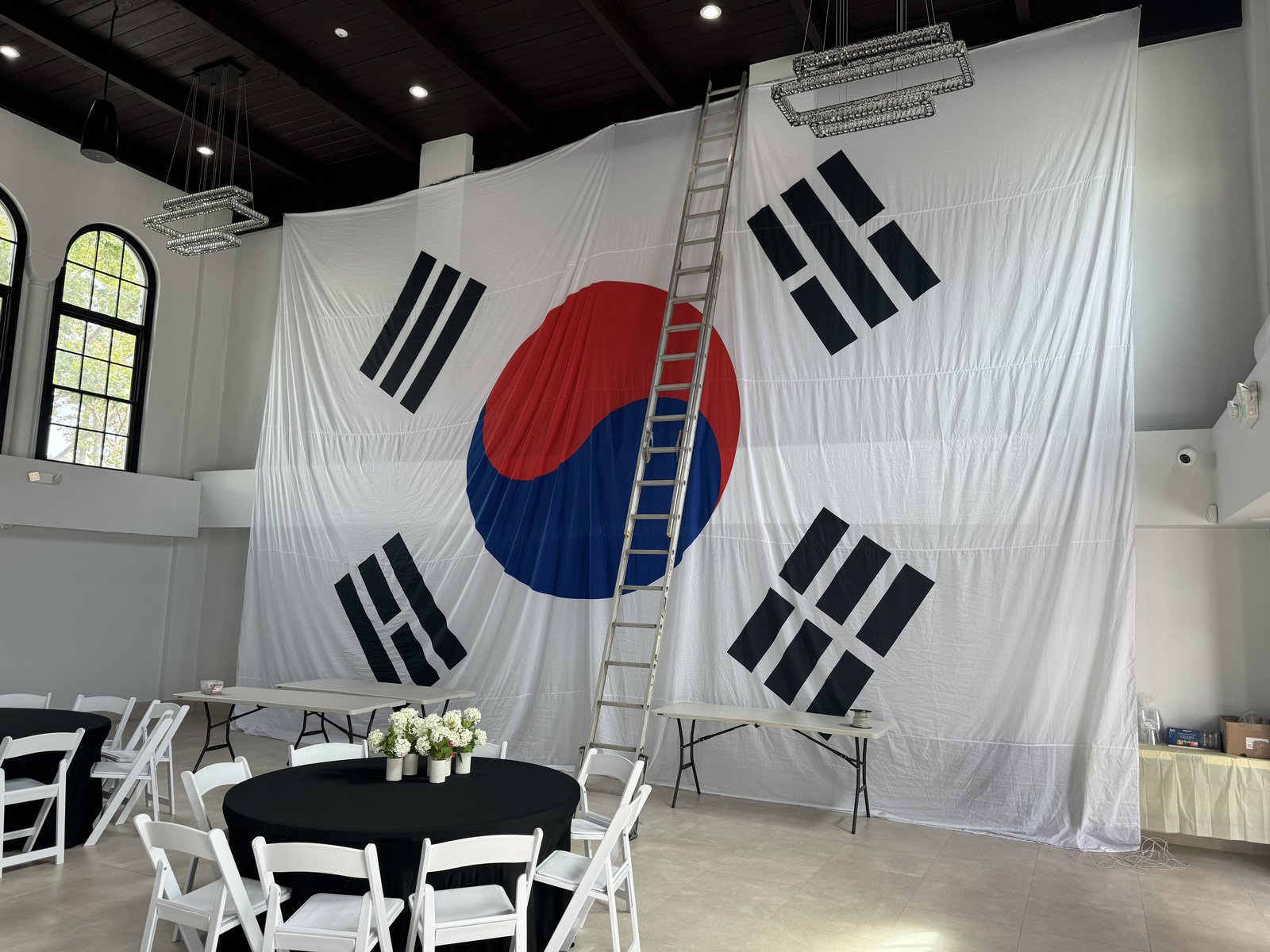Large Korean flag being installed in the hall