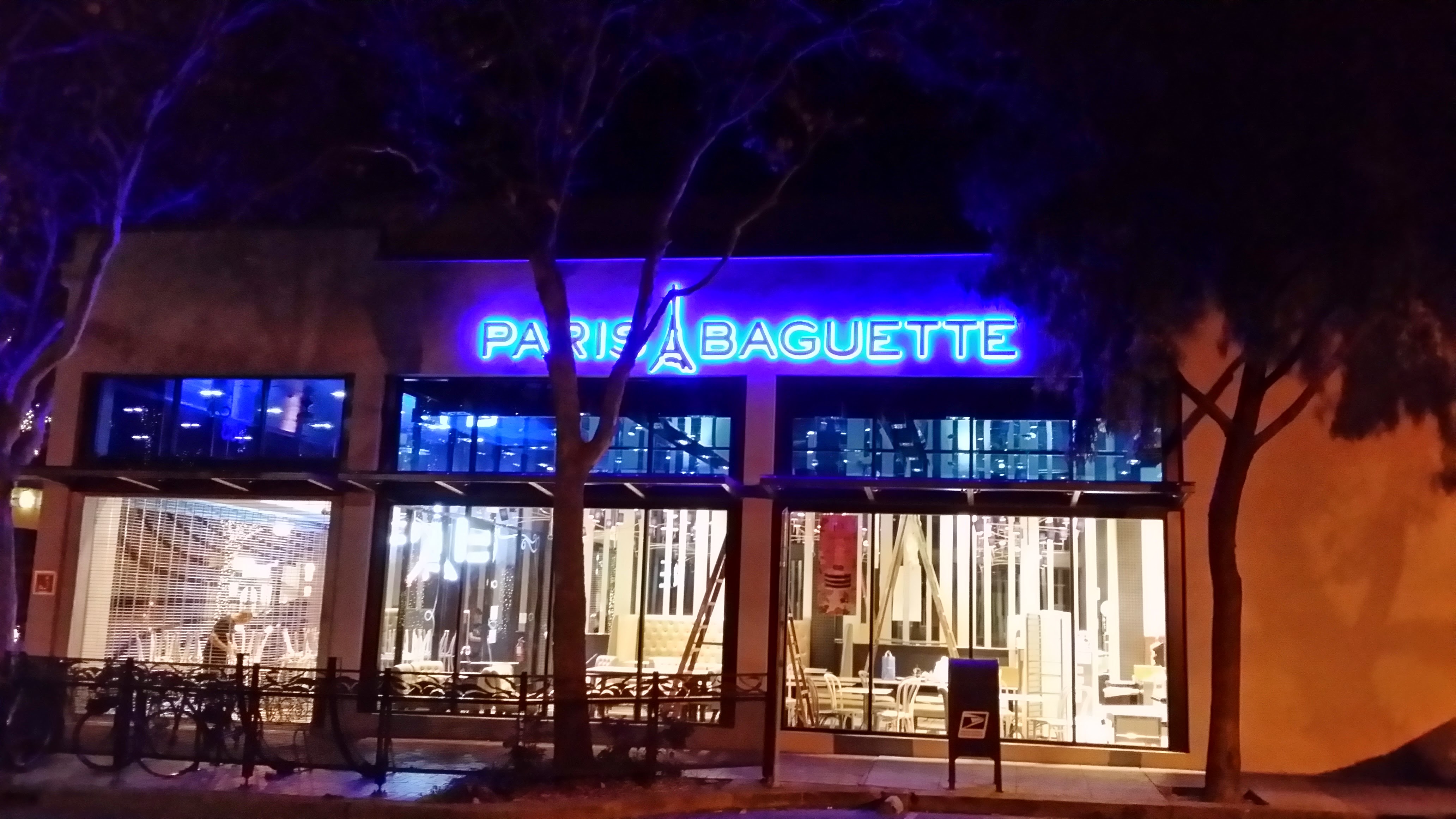 Paris Baguette storefront illuminated blue at night