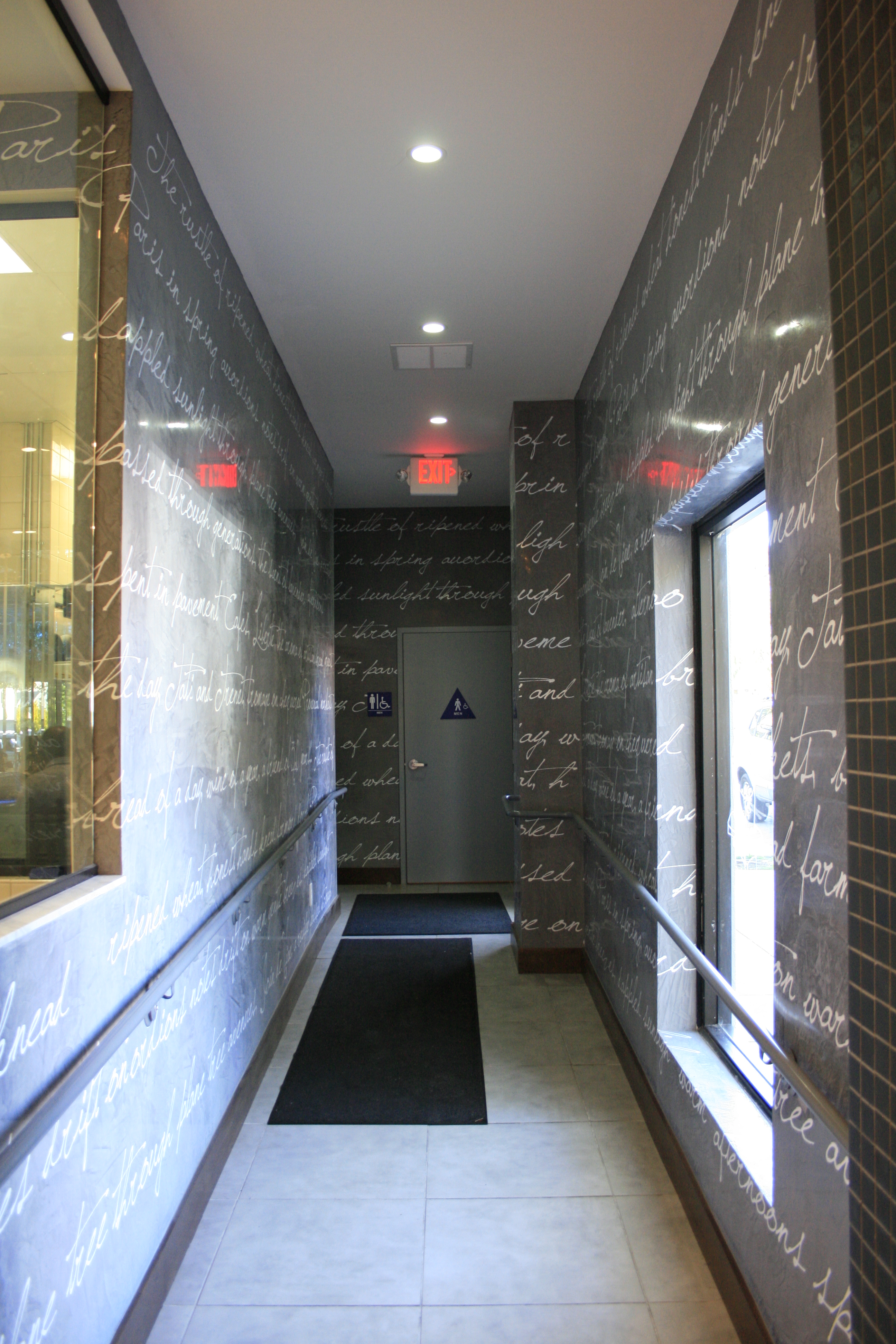 Corridor lined with handwritten French script wall graphics