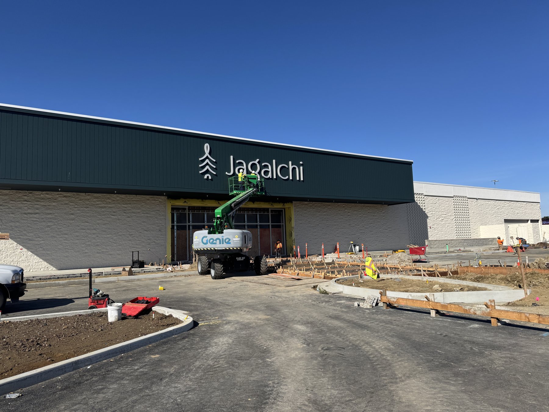 DT Signs crew installing signage with boom lift