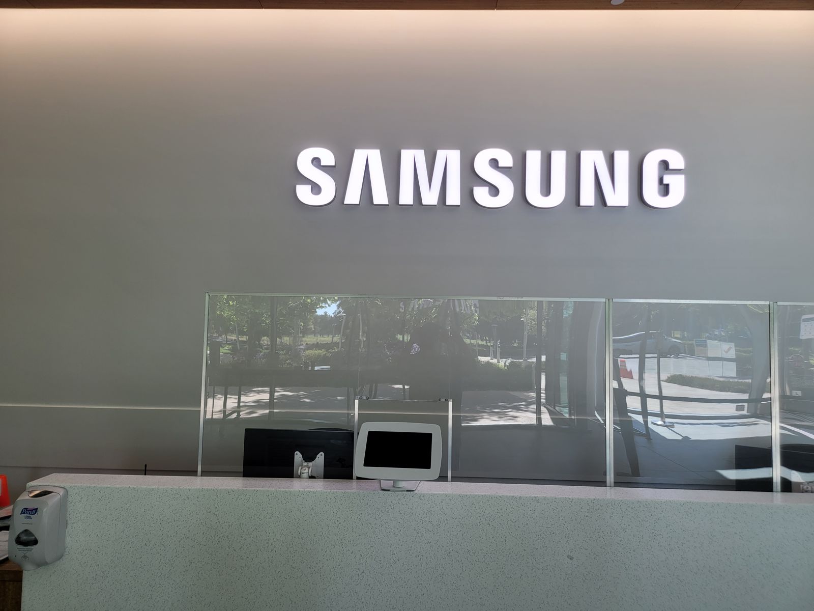 Illuminated white SAMSUNG channel letters glowing evenly on the wall above the reception desk at Samsung's Silicon Valley office.